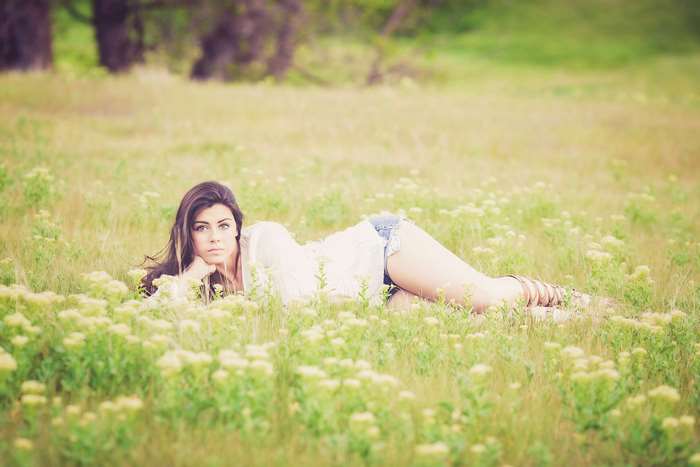 Woman lying in a field of flowers