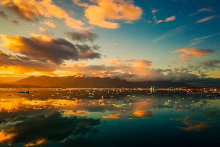 Sunset over a glacial lake with icebergs in Iceland