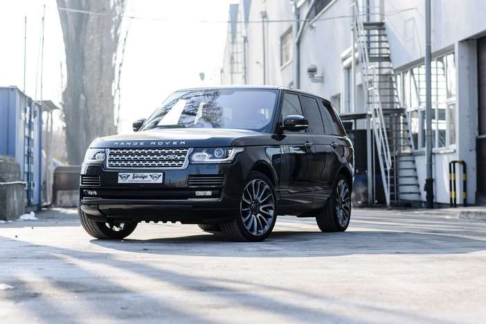 Black Range Rover parked in an urban setting