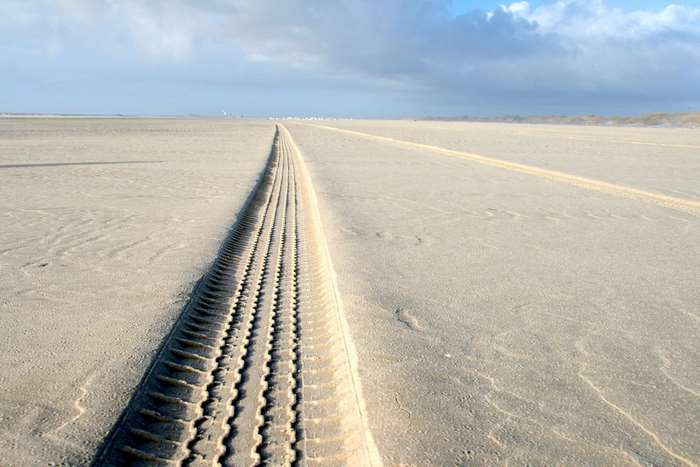 Tire tracks on a sandy beach