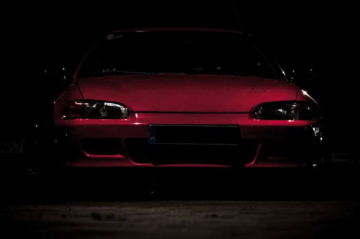 Red Honda Civic EG front view in dark