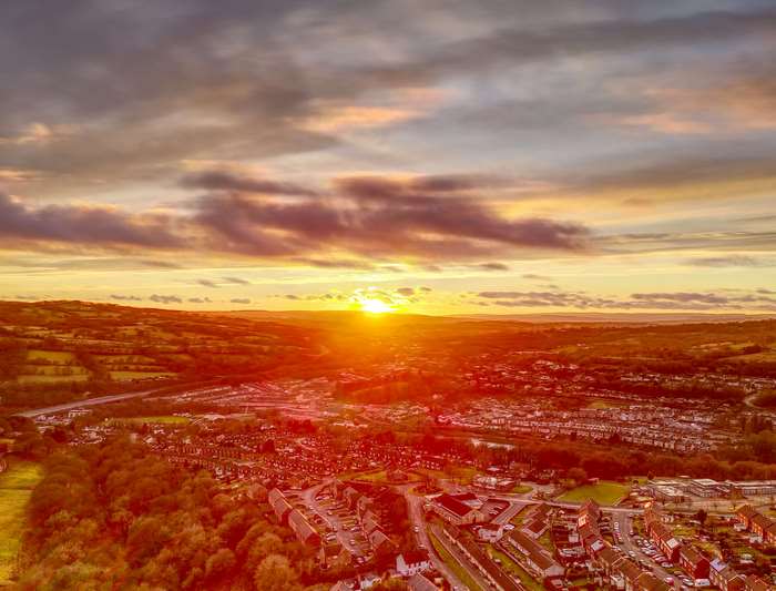 Sunset over rolling hills and a town