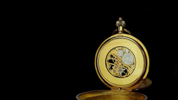 Gold pocket watch with exposed gears mechanism
