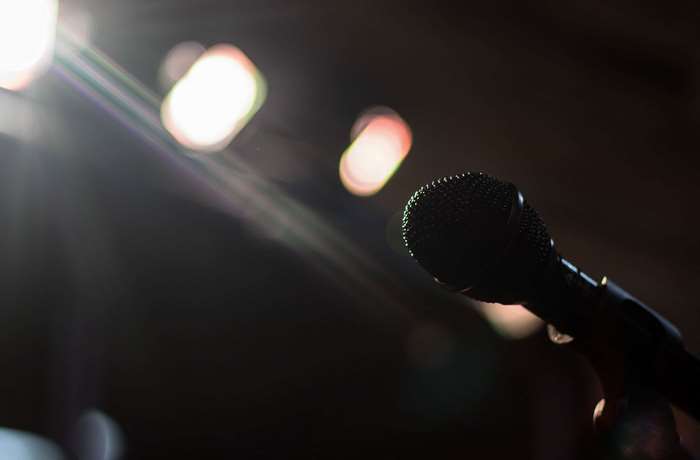 Microphone on a dark stage with bright lights