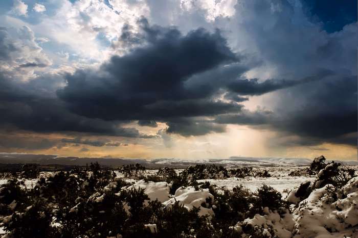 Winter landscape with snow and storm clouds