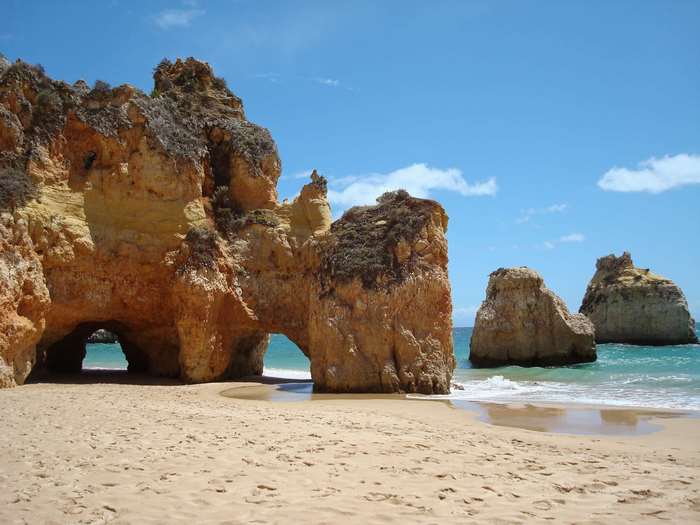 Beach with rock formations and sea in Algarve, Portugal