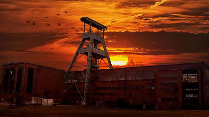 Coal mine tower and buildings at sunset