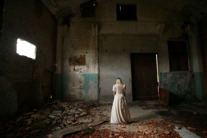 Woman in white dress in abandoned building 4K