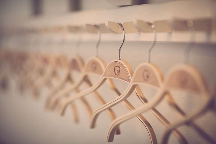 Row of wooden hangers with logos