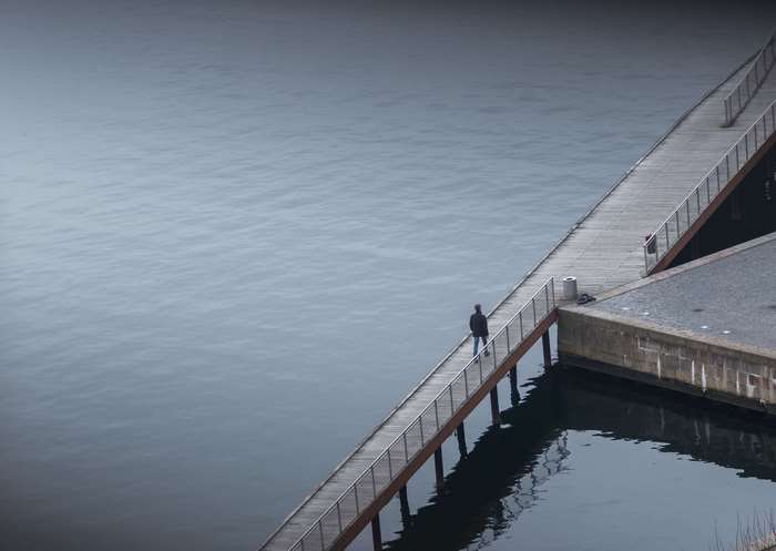 Man walking on a pier over the water