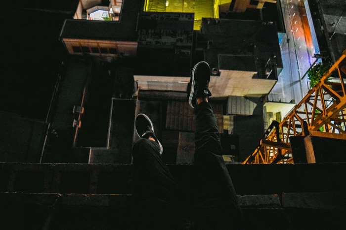Person sitting on rooftop at night