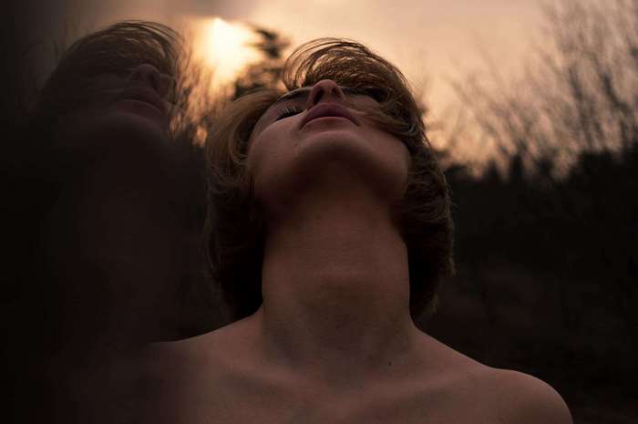 Woman looking up at the sky with reflection