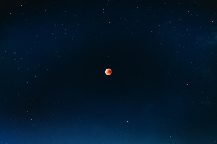 Red Moon in a Starry Night Sky