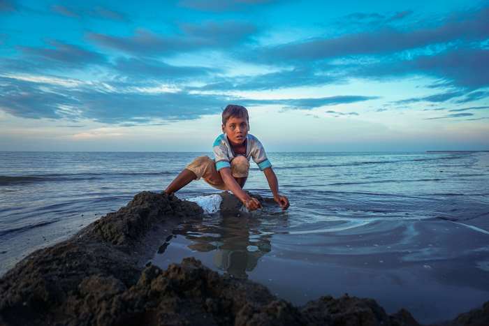 Boy playing in the water at sunset in Aceh, Indonesia 4K