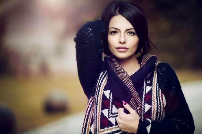 Attractive woman wearing a patterned sweater and scarf