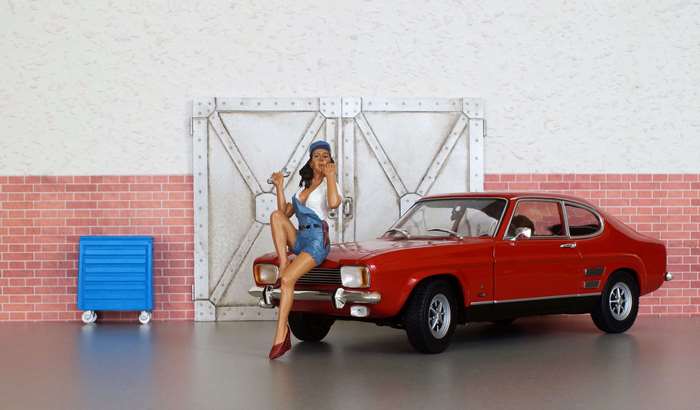 Model of a woman with a wrench and a red Ford Capri