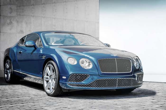 Blue Bentley Continental GT parked on cobblestone