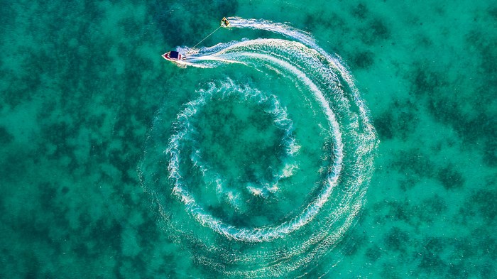 Aerial View of Speed Boat Dragging Water Skier