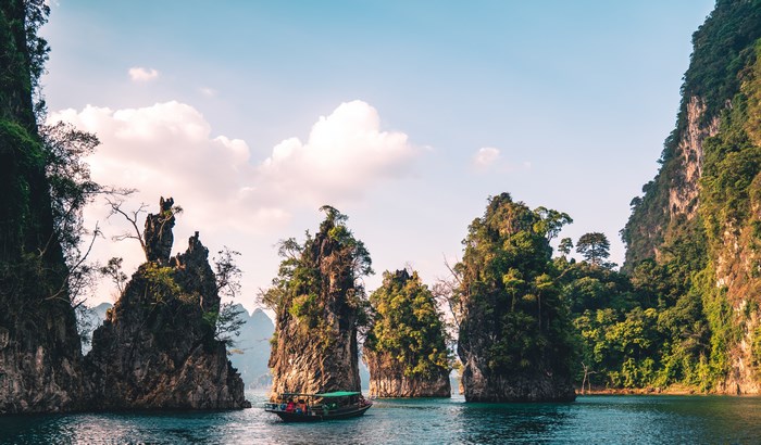 Boat tour among limestone karsts in a lake
