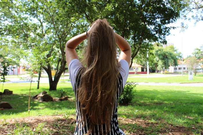 Girl with long brown hair in a park