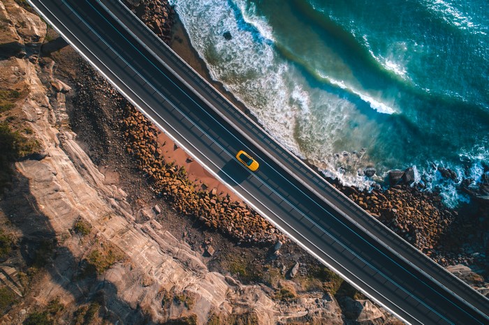 Aerial View of Coastal Highway and Ocean Waves