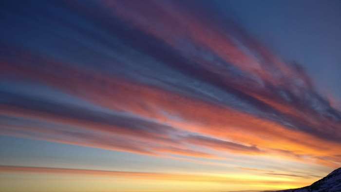 Sunset clouds over a mountain landscape