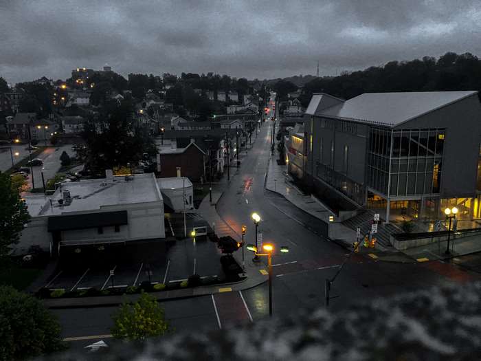 City street at dusk with rain and lights