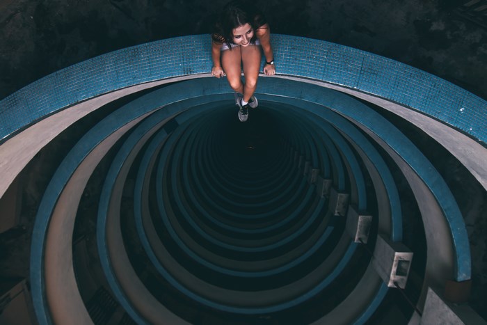 Woman sitting on the edge of a spiral building