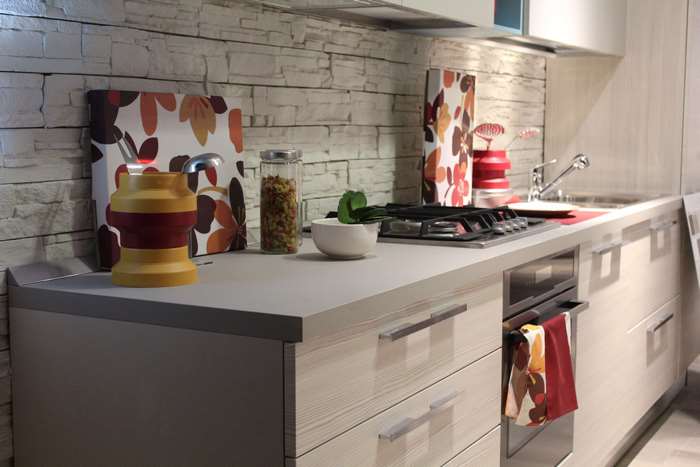 Modern kitchen interior with stone backsplash and floral decor