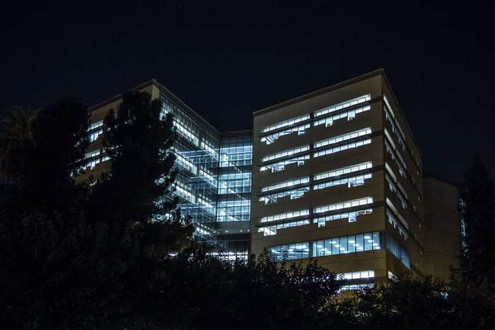 Modern office building at night with illuminated windows