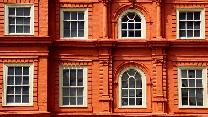 Red brick building with arched and rectangular windows 4K