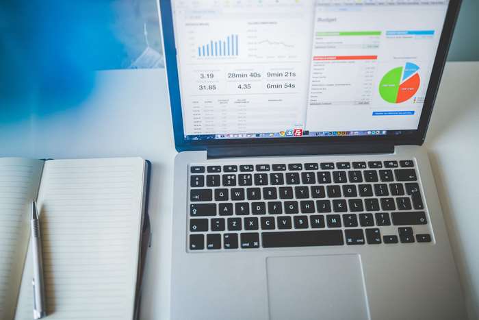 Laptop with charts and notebook