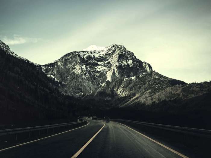 Road leading to snow-capped mountains