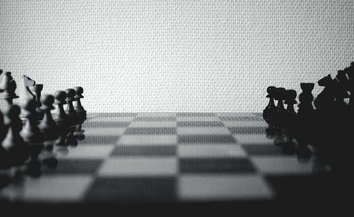Black and White Chessboard with Pieces in Shadow 4K