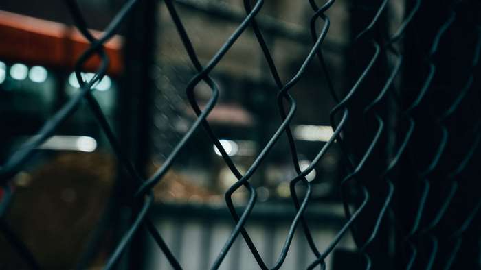 Close up of a dark chain-link fence
