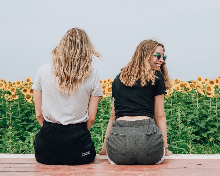 Two women in a sunflower field