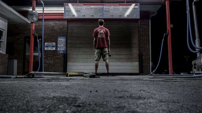 Man at a car wash at night 4K