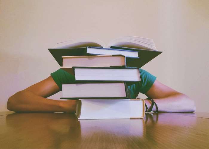 Person with stack of books on head