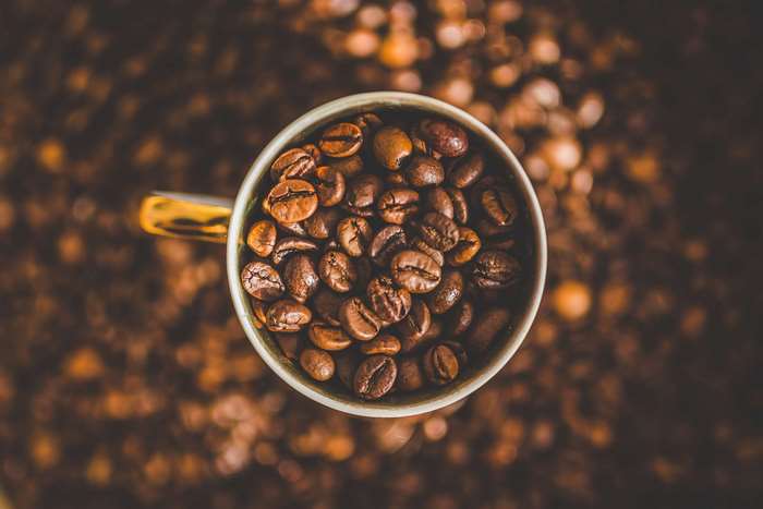 Cup of coffee beans, macro shot