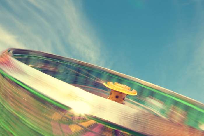 Person on a spinning amusement park ride