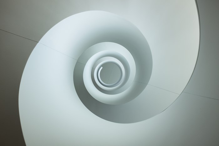 Minimalist White Spiral Staircase Viewed From Above
