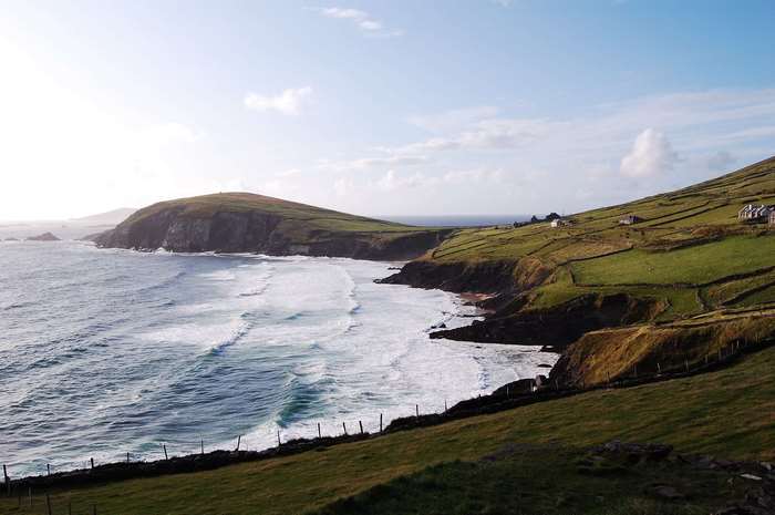 Green hills and ocean waves in Ireland