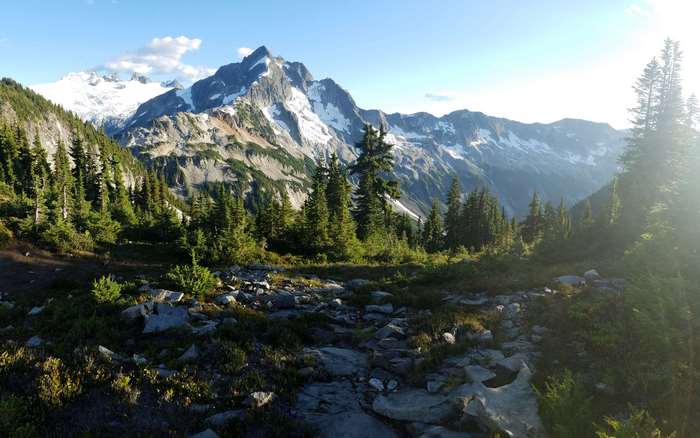 Mountain landscape with snow-capped peaks and evergreen trees