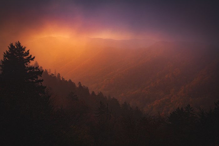 Mountain range with fog during sunrise or sunset