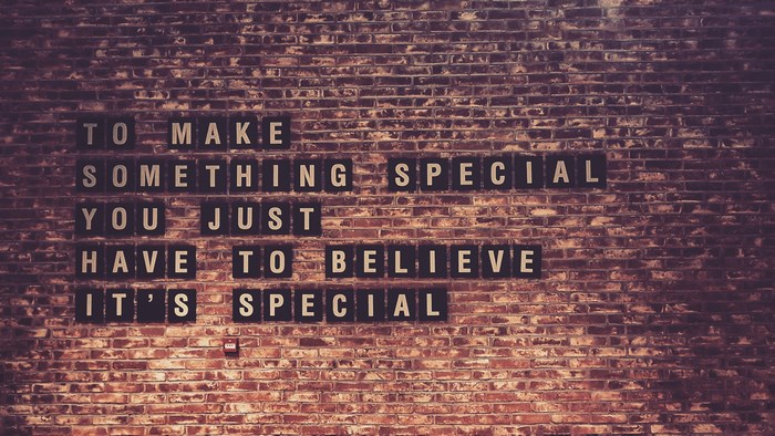 Quote on a brick wall: To make something special