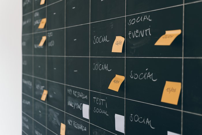 Blackboard with social media planning and sticky notes