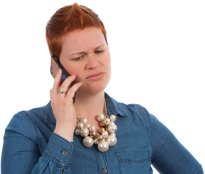 Woman with short red hair talking on a cell phone