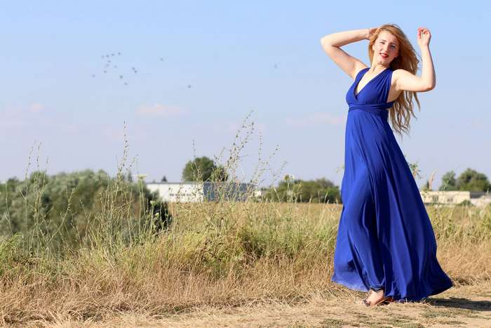 Woman in blue dress in field 4K