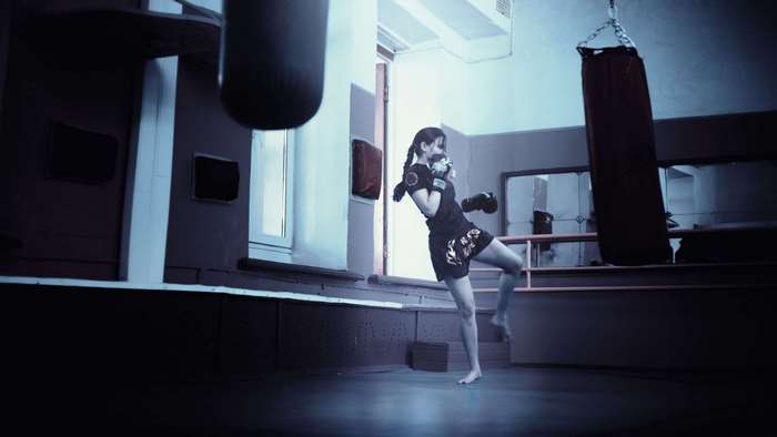 Woman training kickboxing in a gym