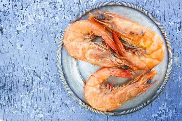 Delicious cooked tiger prawns on wooden background 4K